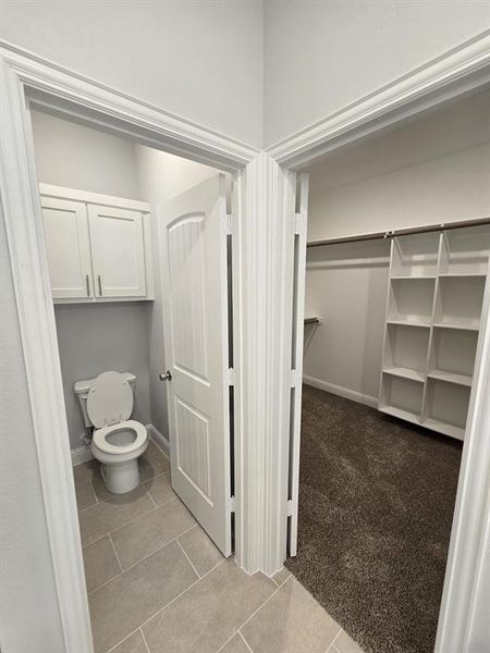 Bathroom with toilet and tile patterned flooring