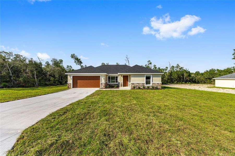 Front exterior of a new home in , Ocala, FL, highlighting curb appeal (Image 27).