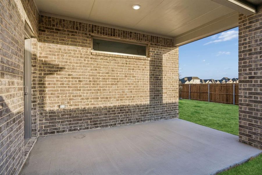 Covered Patio in the Wimbledon home plan by Trophy Signature Homes – REPRESENTATIVE PHOTO Covered Patio in the Wimbledon home plan by Trophy Signature Homes – REPRESENTATIVE PHOTO