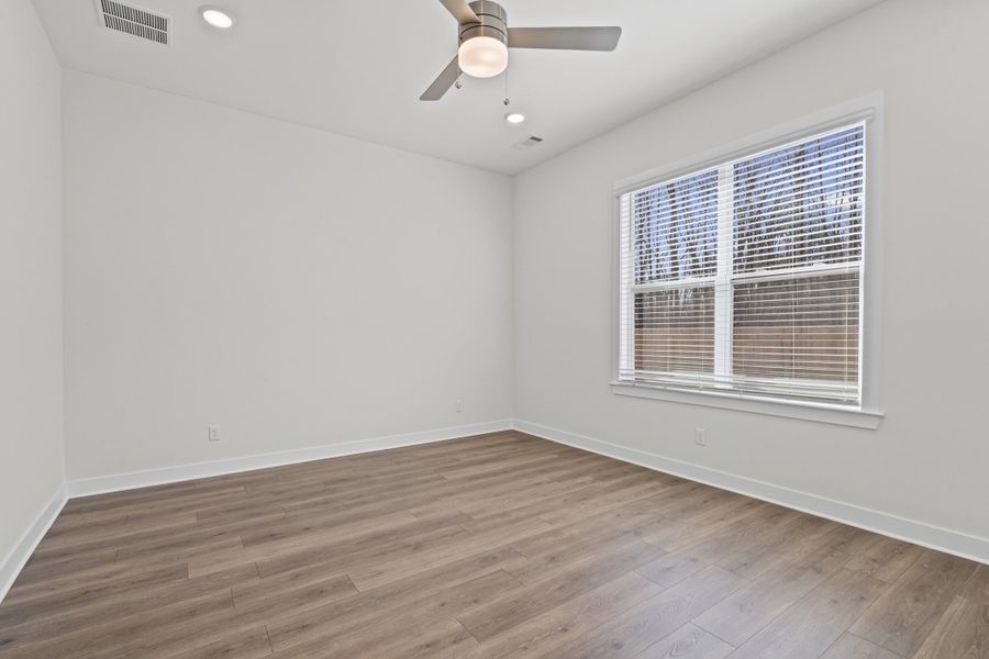 Spare room with wood finished floors, ceiling fan, and recessed lighting