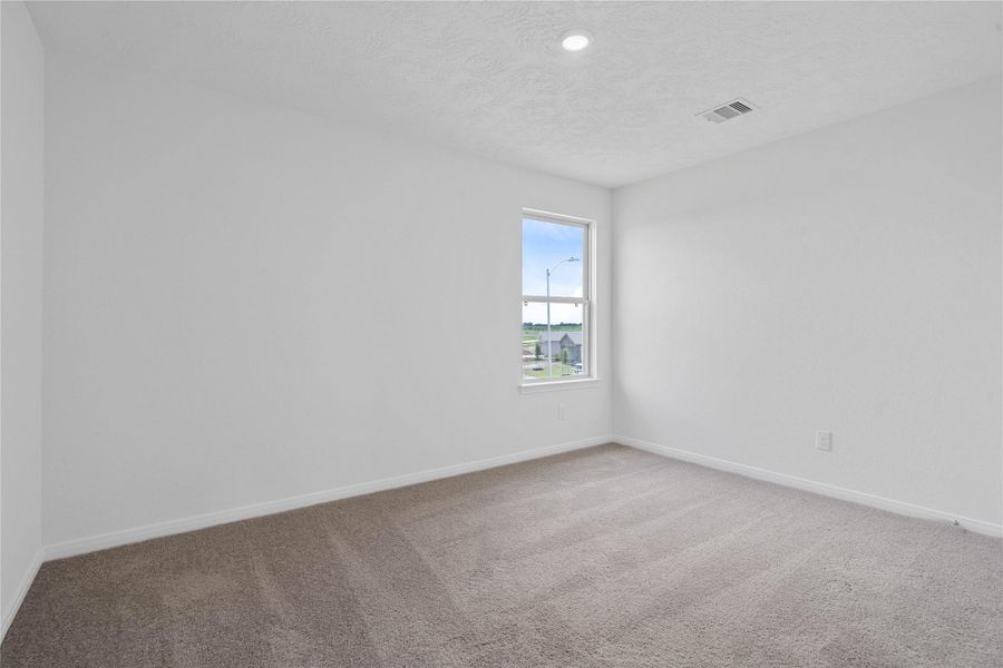 Well appointed secondary bedroom that features plush carpeting, neutral paint tones, recessed lighting, large window, and a generously sized closet. Well appointed secondary bedroom that features plush carpeting, neutral paint tones, recessed lighting, large window, and a generously sized closet.