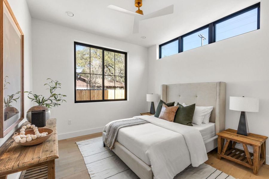 Bedroom featuring light wood-style flooring, ceiling fan, multiple windows, and recessed lighting