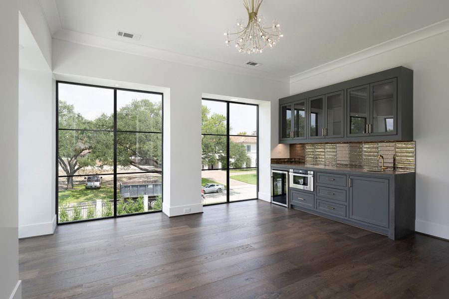 Primary Suite includes a retreat area fireplace, wet bar with storage, wine fridge & microwave.