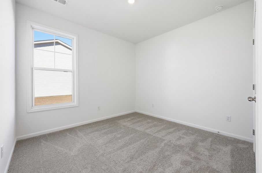Unfurnished room featuring carpet flooring and baseboards Unfurnished room featuring carpet flooring and baseboards