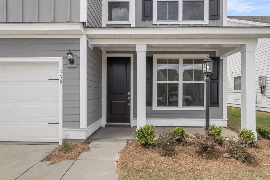 Front exterior of a new home in High Point at Foxbank, Moncks Corner, SC, highlighting curb appeal (Image 1). Front exterior of a new home in High Point at Foxbank, Moncks Corner, SC, highlighting curb appeal (Image 1).