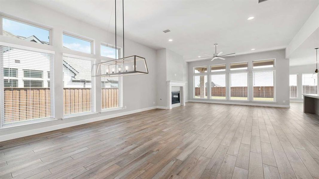 Unfurnished living room featuring light hardwood / wood-style floors and ceiling fan