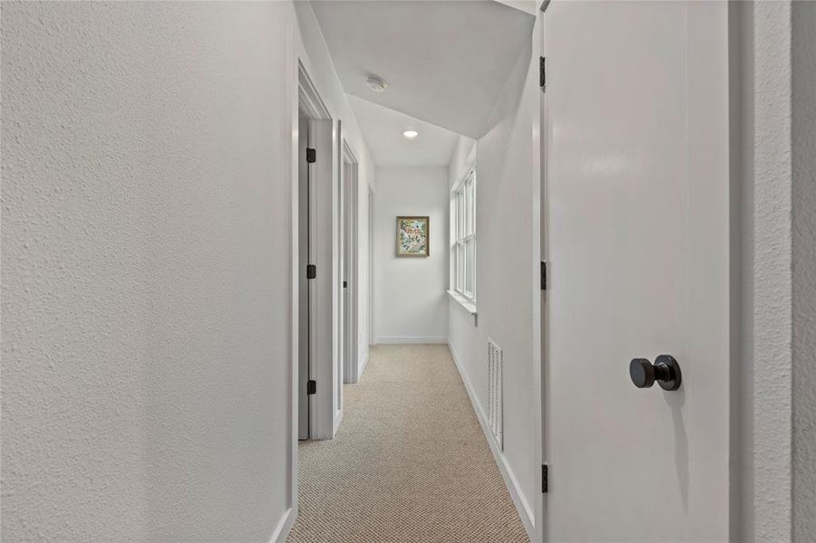 More natural light upstairs. Attic access through the door on right.