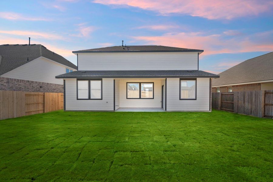 The covered patio is generously sized, providing ample space for various outdoor activities.