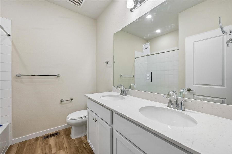 A bathroom with a large mirror.