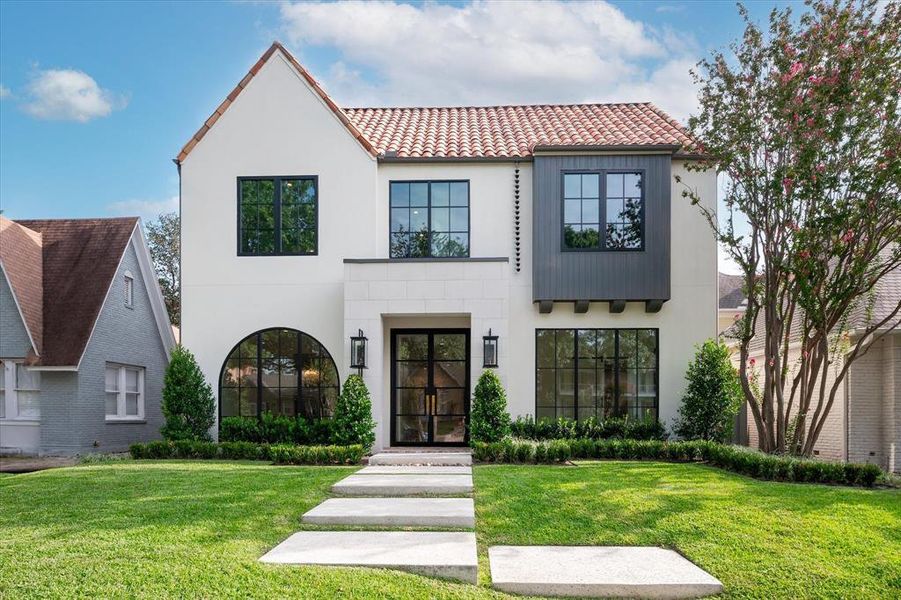 Mediterranean / spanish home with a front yard