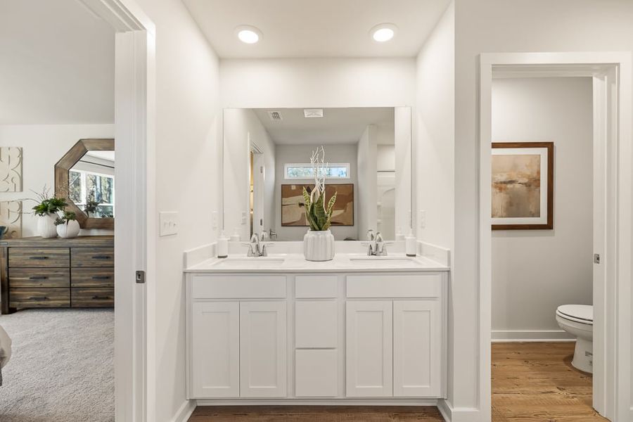 A bathroom with white cabinets. A bathroom with white cabinets.
