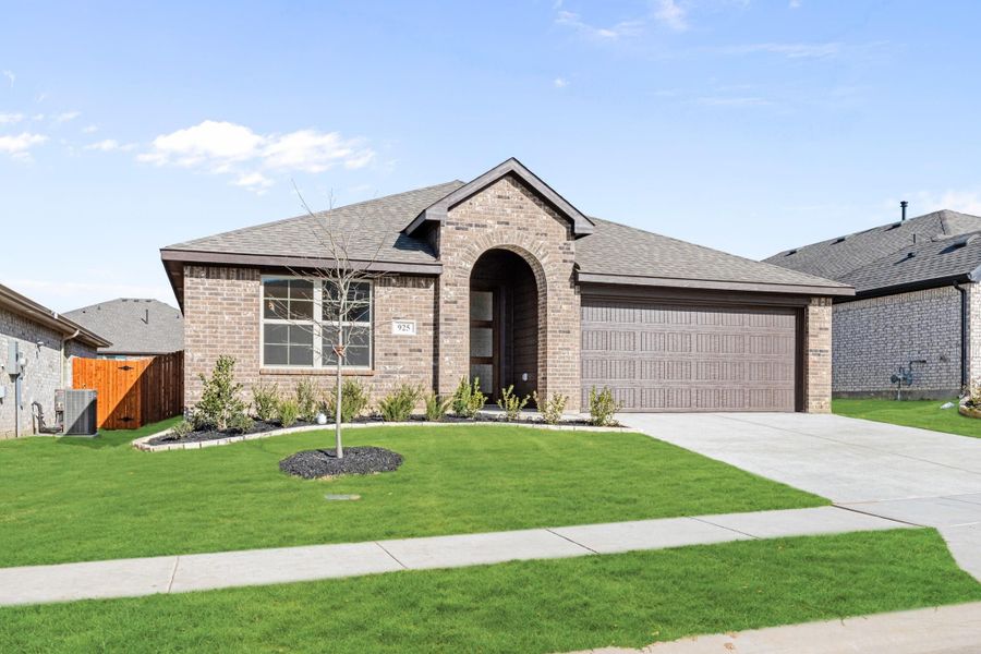 Single-story brick home with arched entry, two-car garage, and manicured front lawn Single-story brick home with arched entry, two-car garage, and manicured front lawn