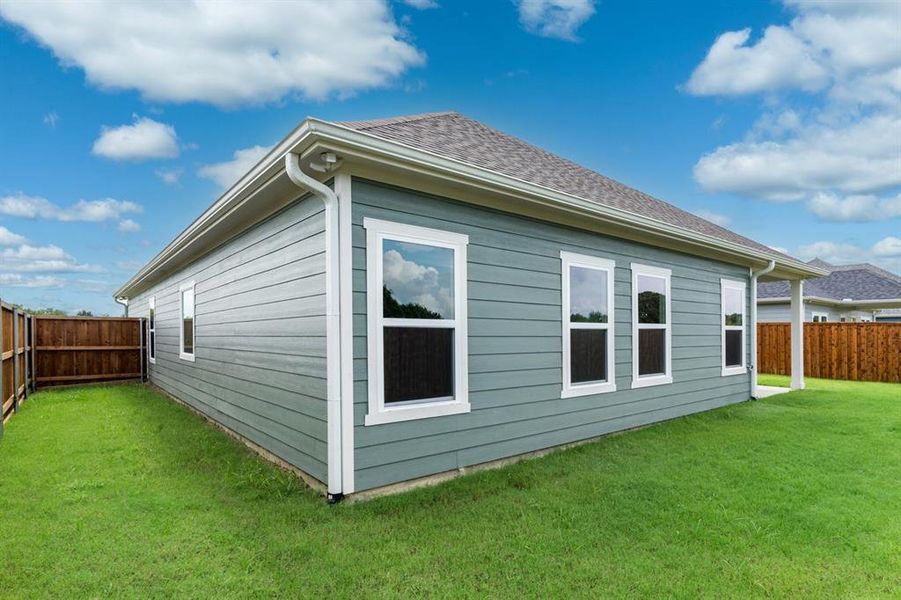 View of home's exterior with a lawn