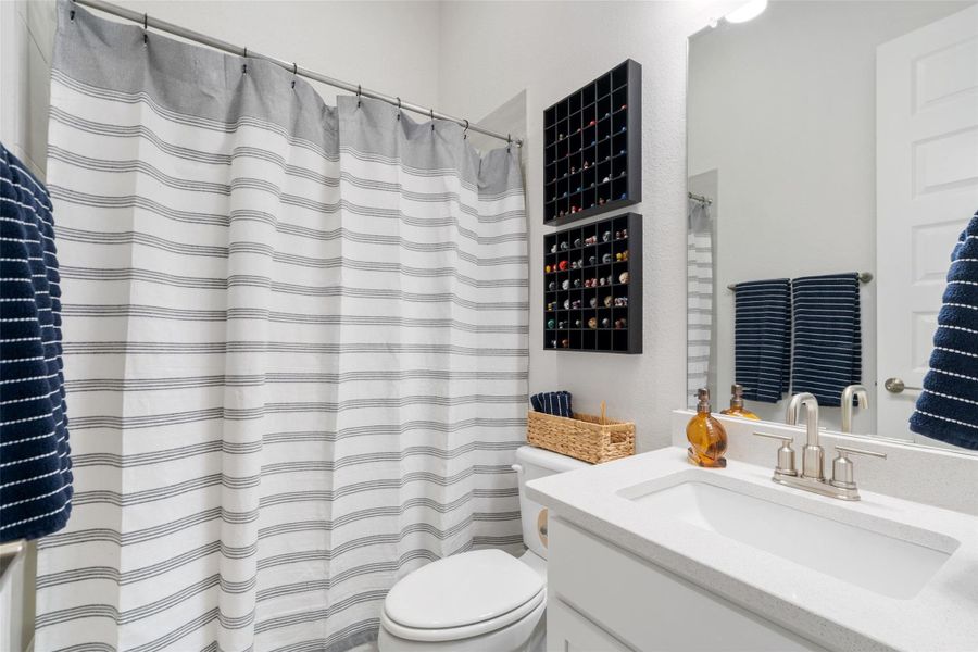 A pristine bathroom features a crisp shower curtain, a sparkling vanity, and bright, well-lit spaces. A pristine bathroom features a crisp shower curtain, a sparkling vanity, and bright, well-lit spaces.