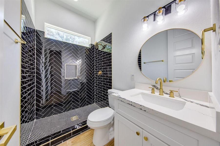 Experience modern elegance in the bathroom with sleek black tiles. This stylish design creates a bold statement, exuding sophistication and offering a stunning backdrop for your self-care rituals.