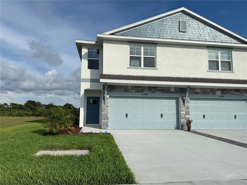 Front exterior of a new home in Emerald Fields, Hudson, FL, highlighting curb appeal (Image 2). Front exterior of a new home in Emerald Fields, Hudson, FL, highlighting curb appeal (Image 2).