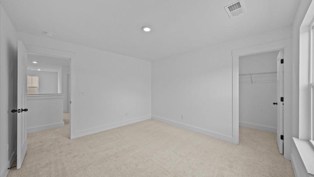 First-class secondary bedroom with comfortable carpeted flooring and generous closet space First-class secondary bedroom with comfortable carpeted flooring and generous closet space