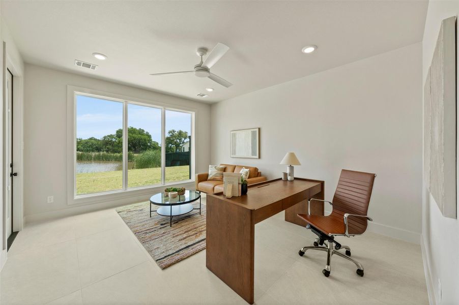 Home office featuring a water view, a ceiling fan, and recessed lighting