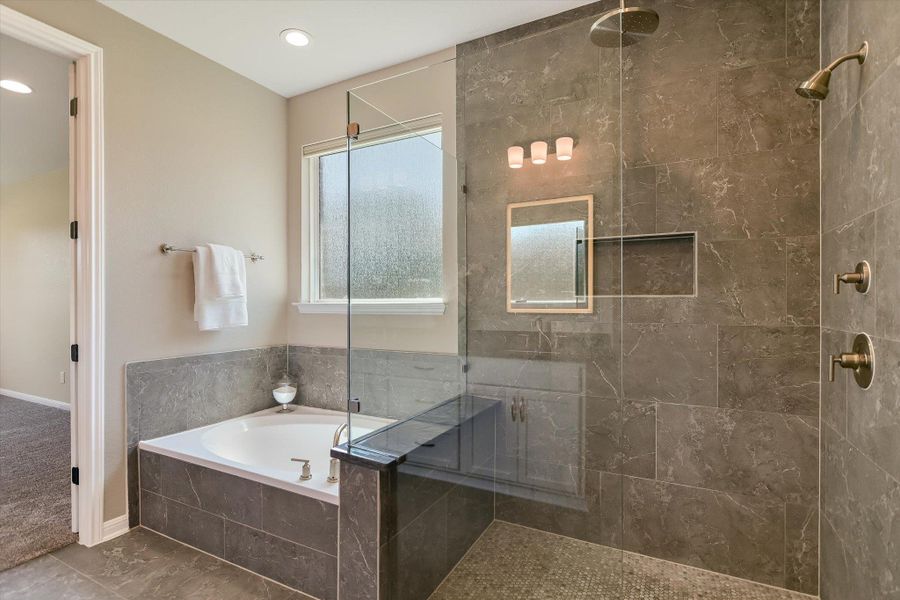 The primary bath offers a walk-in shower, separate tub and dual sinks.