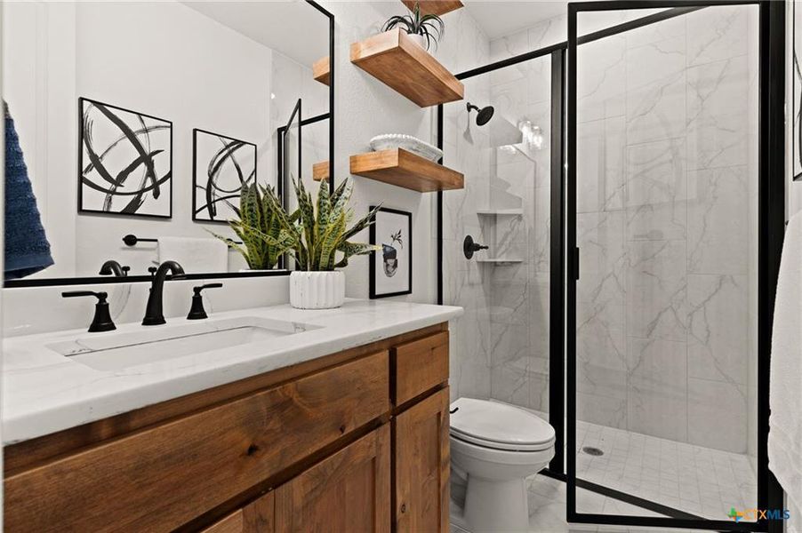 Full bathroom with vanity and a marble finish shower