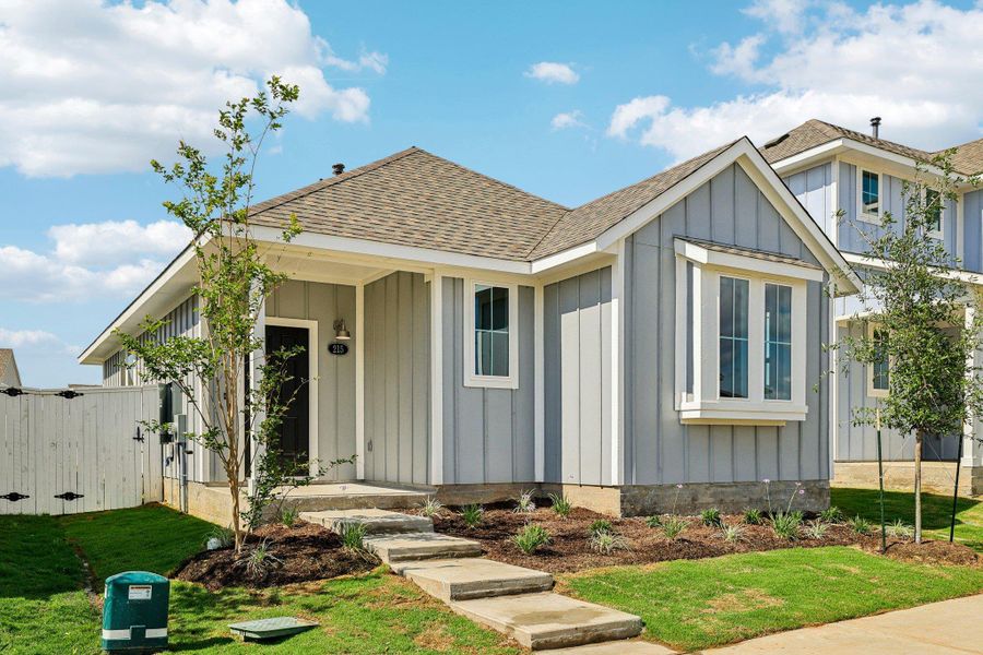 Front exterior of a new home in Harvest Ridge, Elgin, TX, highlighting curb appeal (Image 2). Front exterior of a new home in Harvest Ridge, Elgin, TX, highlighting curb appeal (Image 2).