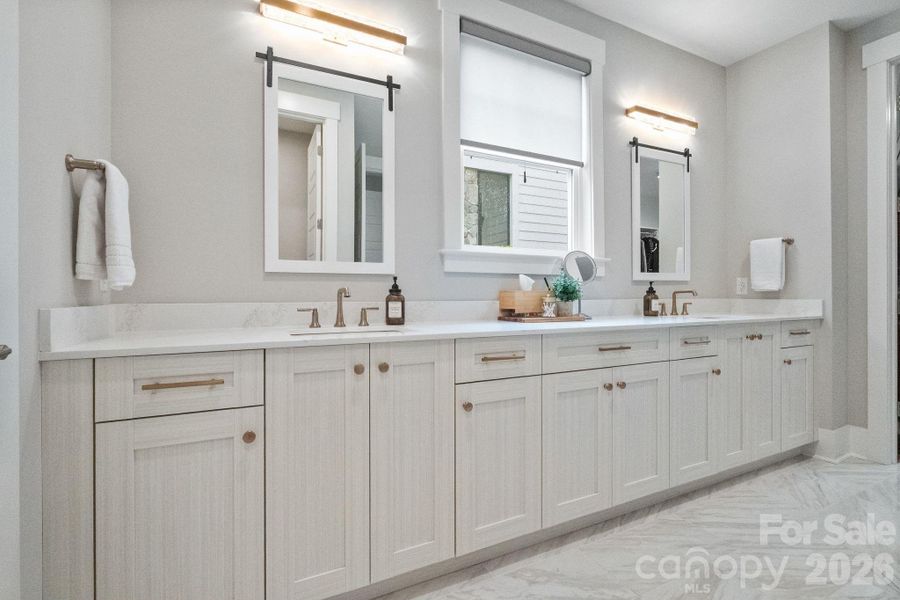 Large Primary Bathroom has dual vanities, quartz counters and large walk-in shower.