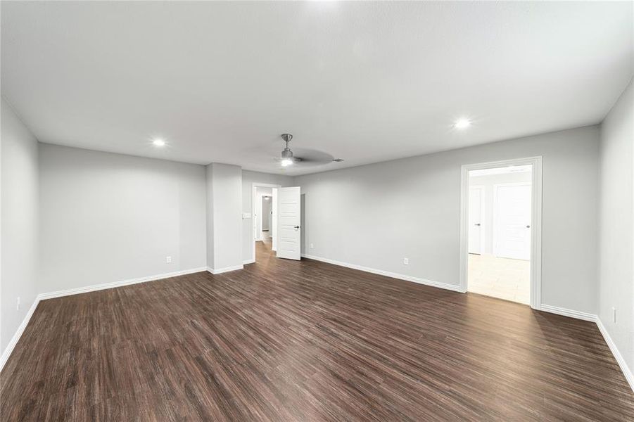 Spare room with recessed lighting, a ceiling fan, and dark wood-style flooring