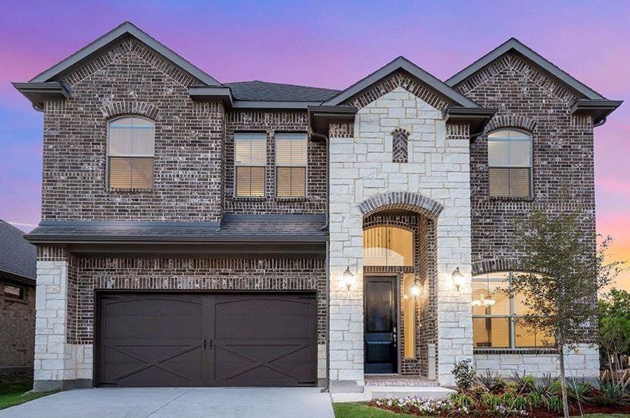 French country inspired facade featuring a garage