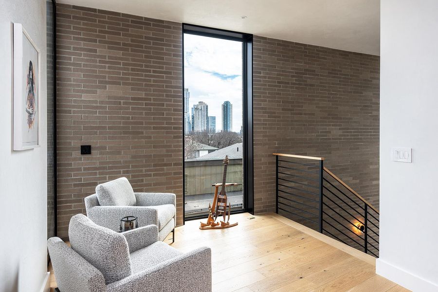 Floor-to-ceiling windows and exposed brick create an impressive entry area with views of the city. Floor-to-ceiling windows and exposed brick create an impressive entry area with views of the city.
