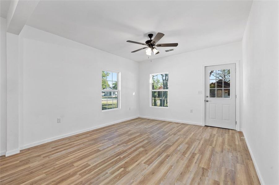 Spare room featuring light wood-style flooring and ceiling fan Spare room featuring light wood-style flooring and ceiling fan