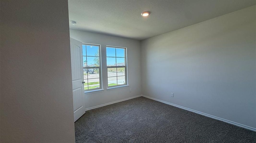 Carpeted room with two windows, painted walls, and recessed lighting