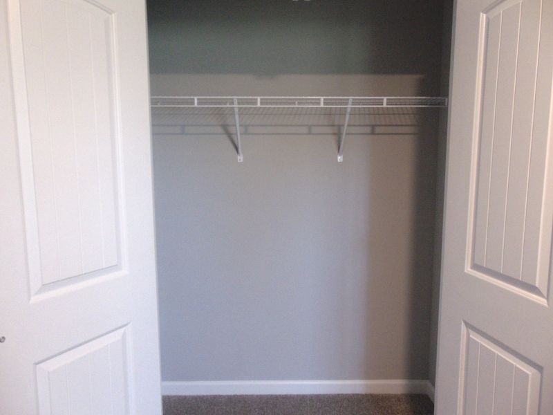 The second bedroom with large windows for that nature lighting, as well as your closet with a convenient rack.