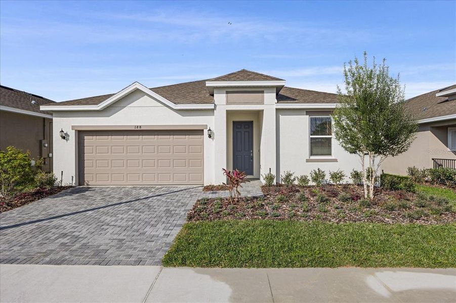 Front exterior of a new home in Tarpon Bay, Haines City, FL, highlighting curb appeal (Image 1). Front exterior of a new home in Tarpon Bay, Haines City, FL, highlighting curb appeal (Image 1).