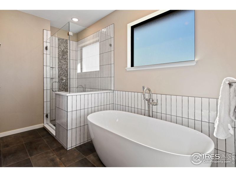 Primary Suite's large soaking tub and walk in shower. On demand hot water is another cost saving and comfort bonus.