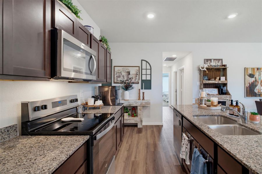 Gleaming stone countertops and dark wood cabinetry define this modern kitchen design. Gleaming stone countertops and dark wood cabinetry define this modern kitchen design.