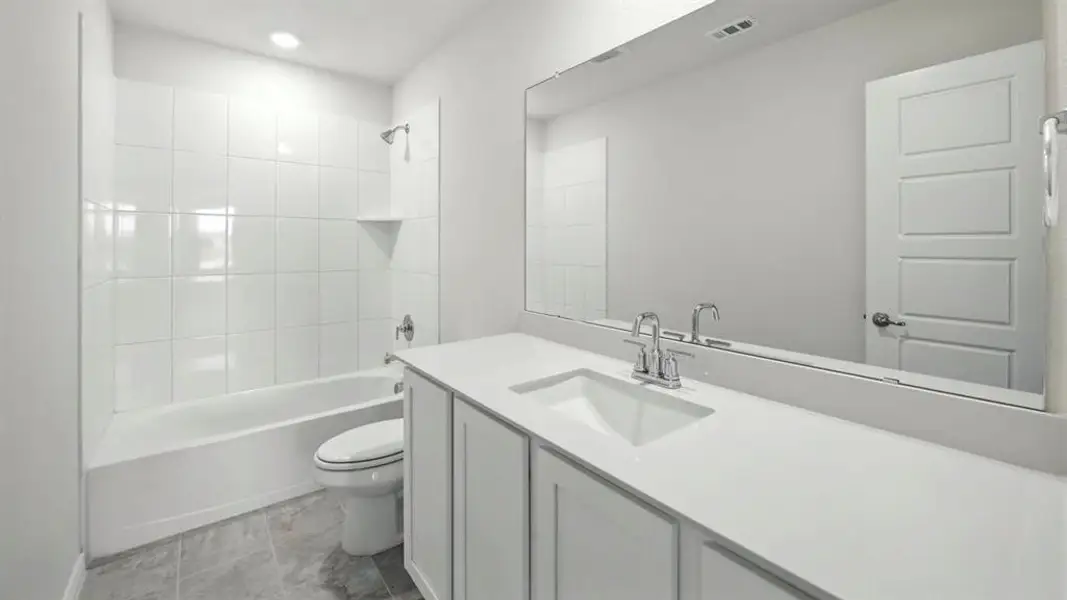 Bathroom featuring vanity and shower / bath combination