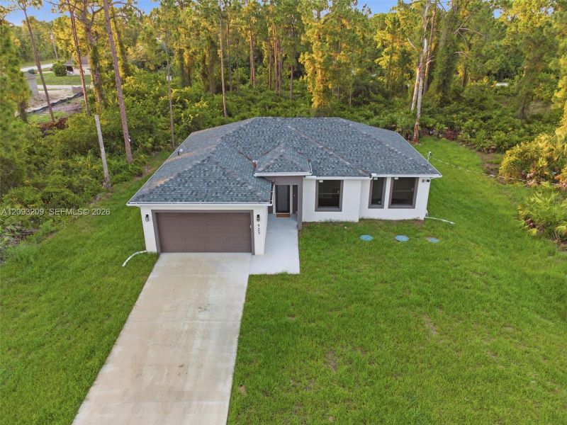 Front exterior of a new home in , Lehigh Acres, FL, highlighting curb appeal (Image 25).