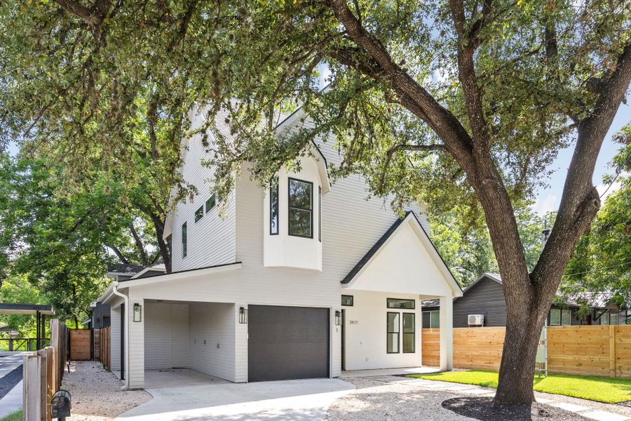 View of front facade featuring an attached garage and driveway View of front facade featuring an attached garage and driveway