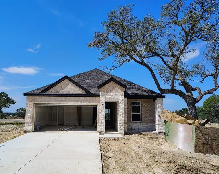 Front exterior of a new home in Woodside, Georgetown, TX, highlighting curb appeal (Image 1).