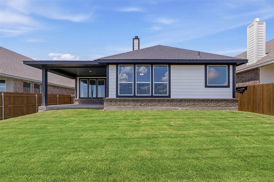 Expansive green lawn with a covered patio Expansive green lawn with a covered patio