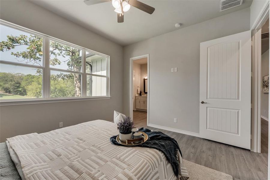 Bedroom featuring ceiling fan and light wood-type flooring