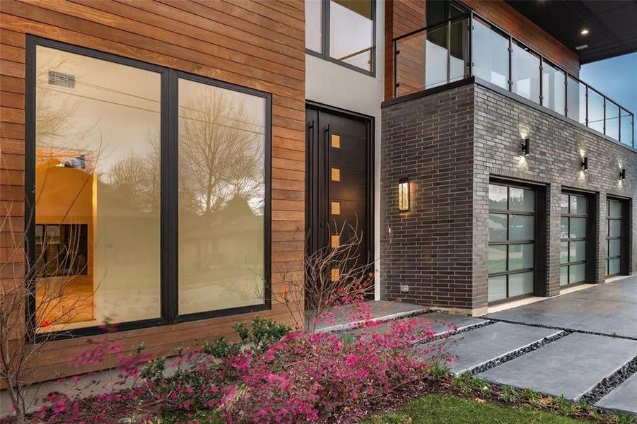 Modern exterior featuring wood-finish siding and dark brickwork Modern exterior featuring wood-finish siding and dark brickwork