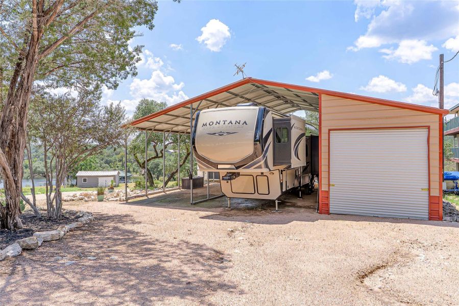 Convenient RV space with hookup plus insulated storage for well and water equipment.