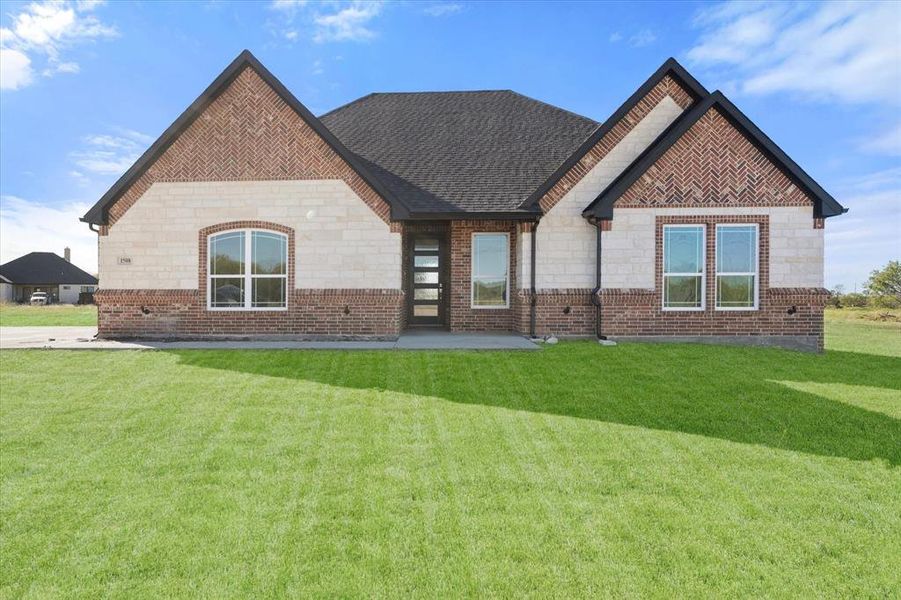 Rear view of property with a lawn