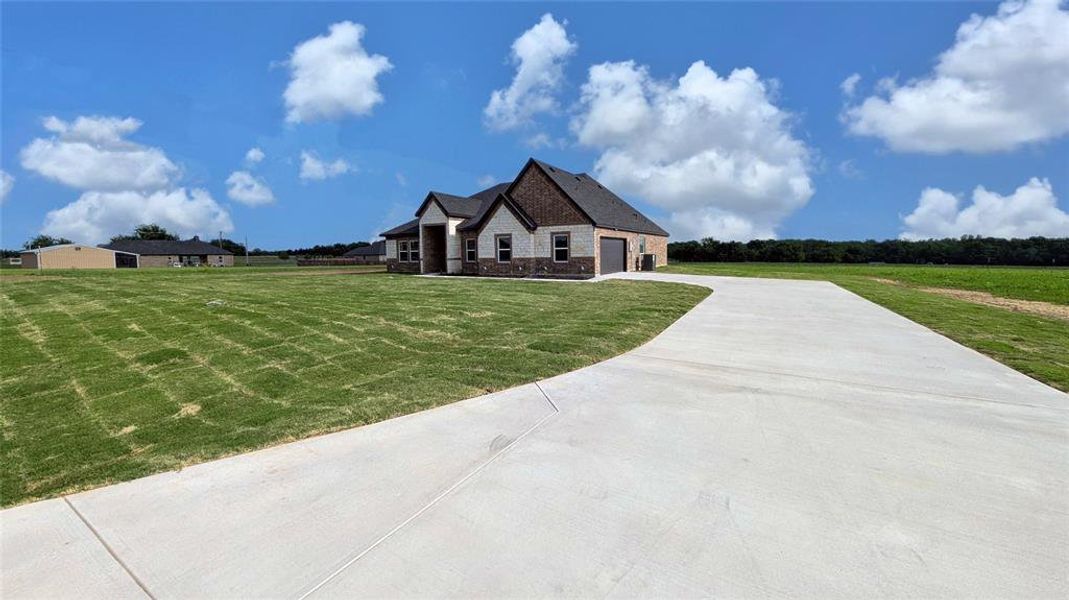 Front exterior of a new home in , Greenville, TX, highlighting curb appeal (Image 23).