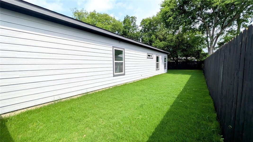 View of yard with a fenced backyard