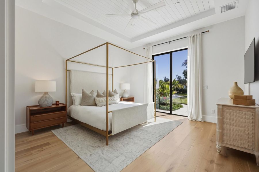 Owner's suite with shiplap tray ceiling, 2 walk in closets & access to backyard