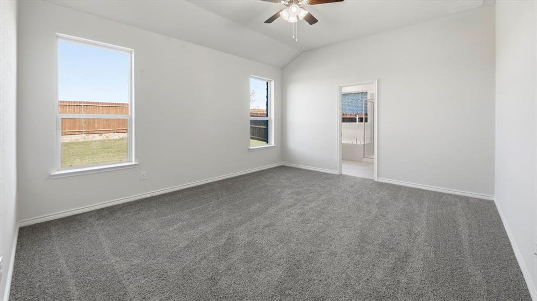 Unfurnished bedroom featuring lofted ceiling, carpet, ceiling fan, and ensuite bath Unfurnished bedroom featuring lofted ceiling, carpet, ceiling fan, and ensuite bath
