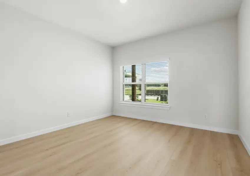 Spacious master suite has a large window for natural light.