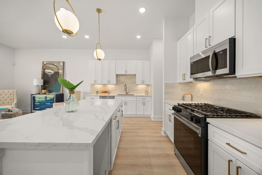 This kitchen is by far any chef’s dream! This spacious kitchen features high ceilings, white cabinets, quartz countertops, SS appliances, modern tile backsplash, recessed lighting with additional custom pendant lighting, extended counter space, granite kitchen island with double sink and space for breakfast bar and a walk-in pantry all overlooking your huge family room. This kitchen is by far any chef’s dream! This spacious kitchen features high ceilings, white cabinets, quartz countertops, SS appliances, modern tile backsplash, recessed lighting with additional custom pendant lighting, extended counter space, granite kitchen island with double sink and space for breakfast bar and a walk-in pantry all overlooking your huge family room.